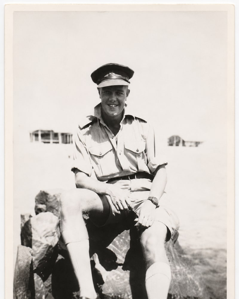 Historical family photograph of Harry in Australian military uniform, seated outdoors.